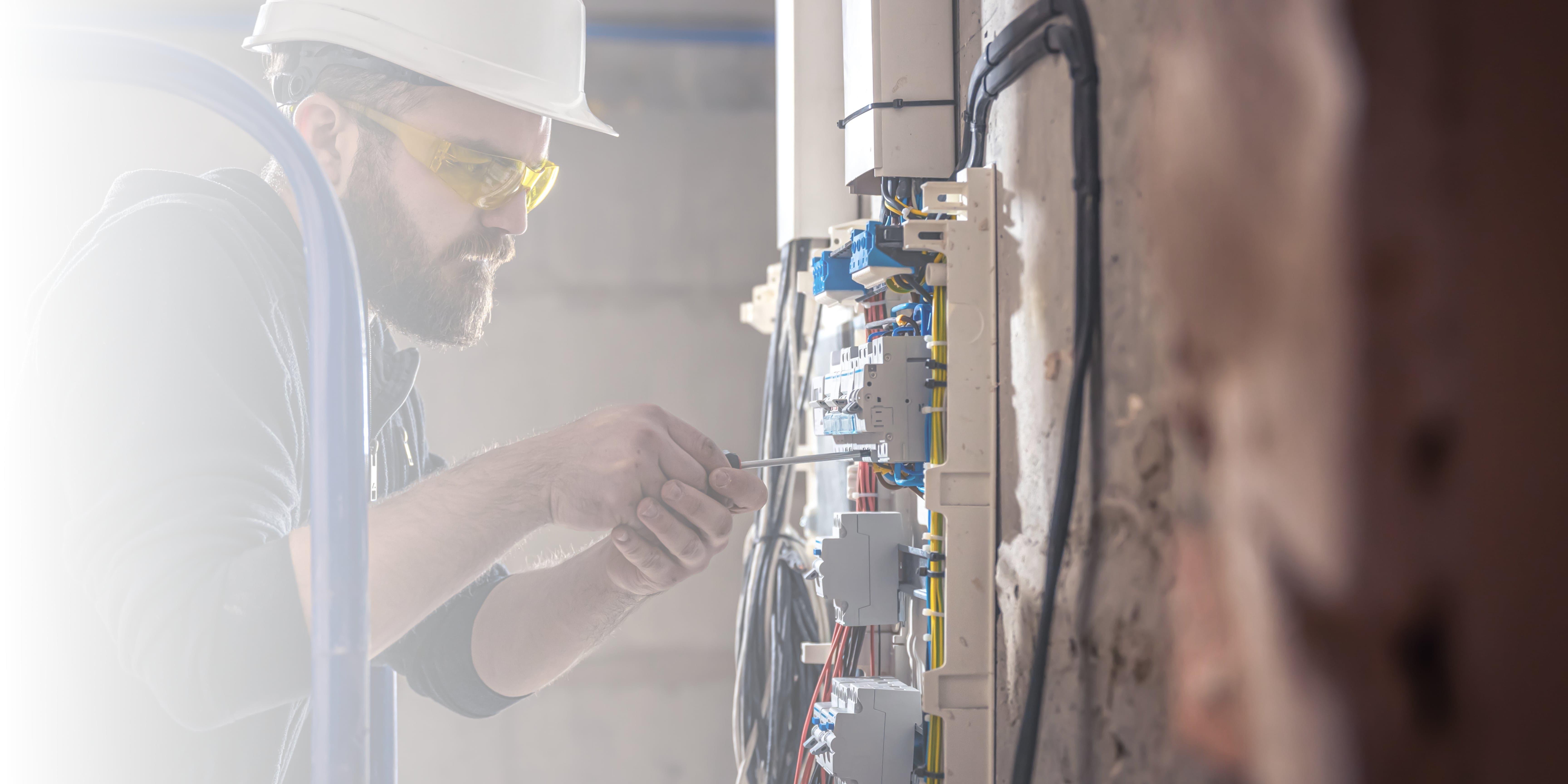 Expert Electrician fixing wiring in an apartment inLiverpool